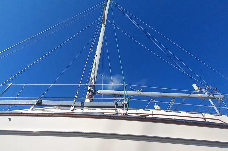 Ivory Star Yacht Photos Pics Sailboat mast and rigging of 1999 Island Packet 350 against clear blue sky.