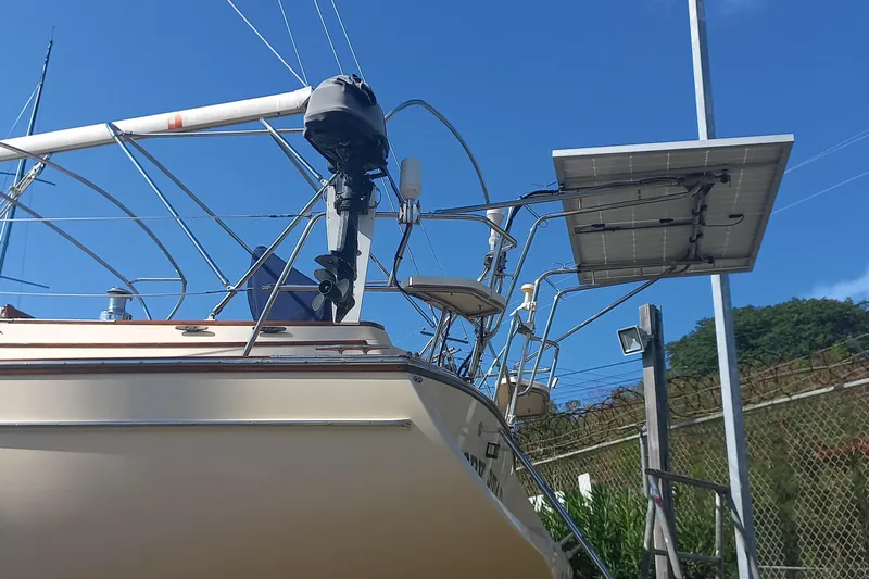 Ivory Star Yacht Photos Pics 1999 Island Packet 350 sailboat with solar panel, docked under clear blue sky.