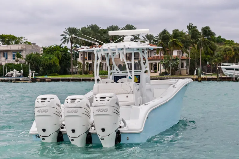  Yacht Photos Pics 2021 Yellowfin 36 Offshore boat with triple engines on turquoise water.