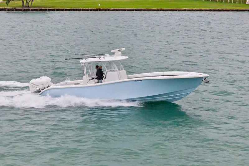  Yacht Photos Pics 2021 Yellowfin 36 Offshore boat cruising on water, side view.