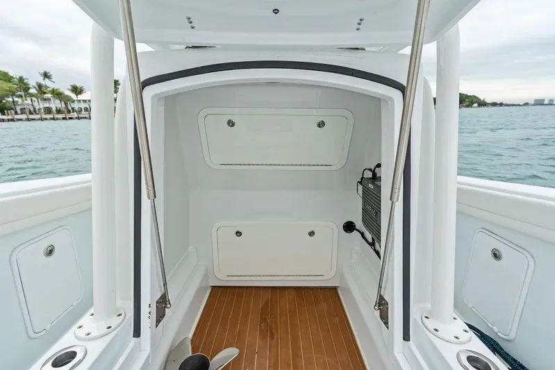  Yacht Photos Pics 2021 Yellowfin 36 Offshore boat interior with storage compartments and wooden flooring.