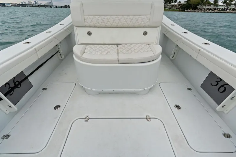  Yacht Photos Pics 2021 Yellowfin 36 Offshore boat interior with cushioned seating and storage compartments.