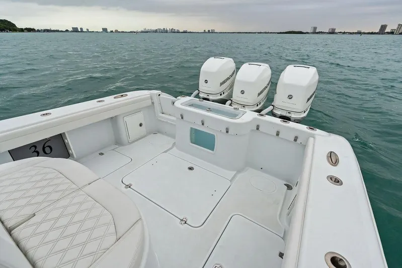  Yacht Photos Pics 2021 Yellowfin 36 Offshore boat with triple Mercury engines on open water.