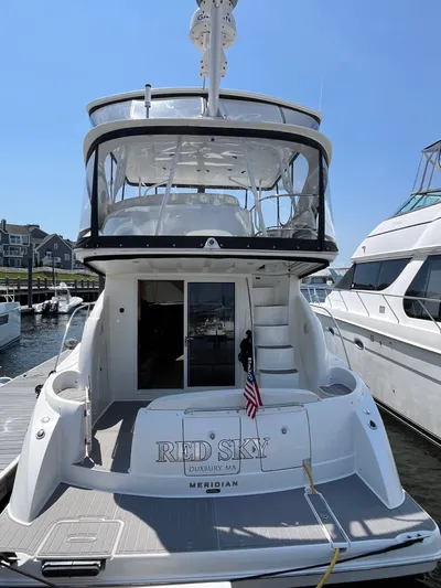  Yacht Photos Pics 2008 Meridian 391 Sedan yacht docked, rear view with American flag and "Red Sky" name.