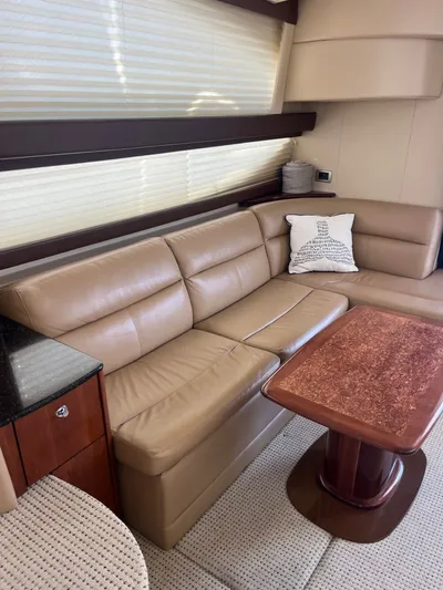  Yacht Photos Pics Luxurious interior of 2008 Meridian 391 Sedan with beige leather seating and wooden table.