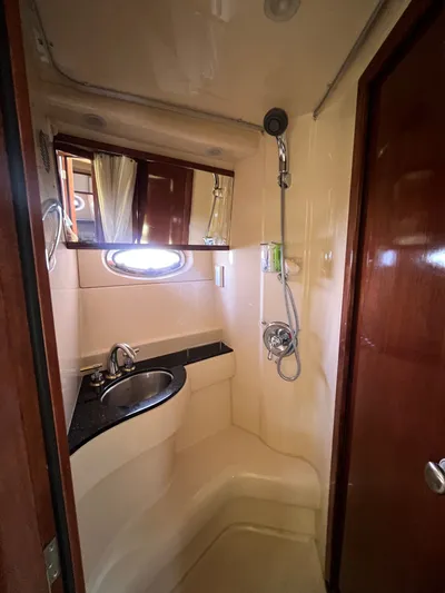  Yacht Photos Pics Compact bathroom in 2008 Meridian 391 Sedan yacht with sink, shower, and mirror.