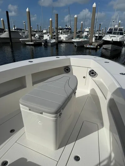 Seavee Yacht Photos Pics 2025 SeaVee 320Z boat interior with cushioned seating, docked at marina.
