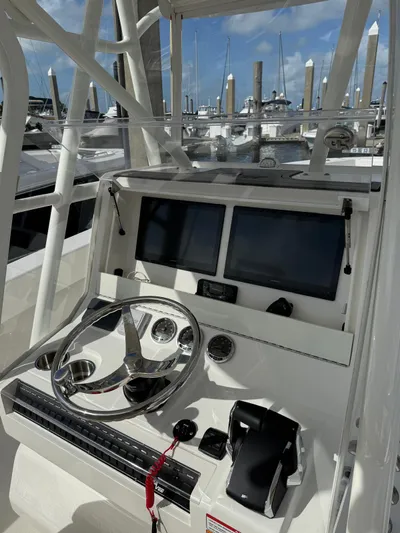 Seavee Yacht Photos Pics 2025 SeaVee 320Z boat helm with dual screens and modern controls at marina.