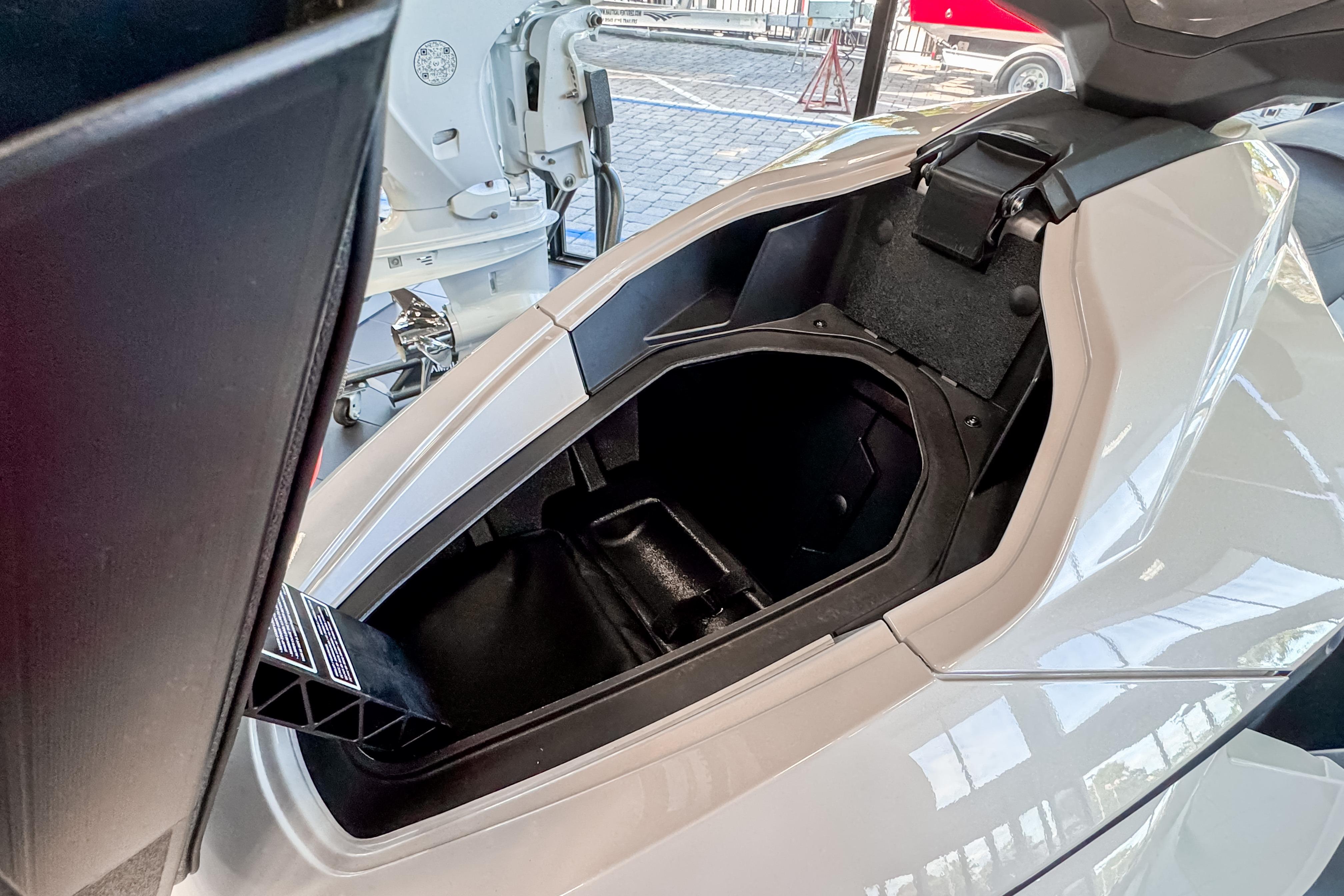 Open storage compartment of 2025 Taiga Orca P2 watercraft, showcasing interior space.