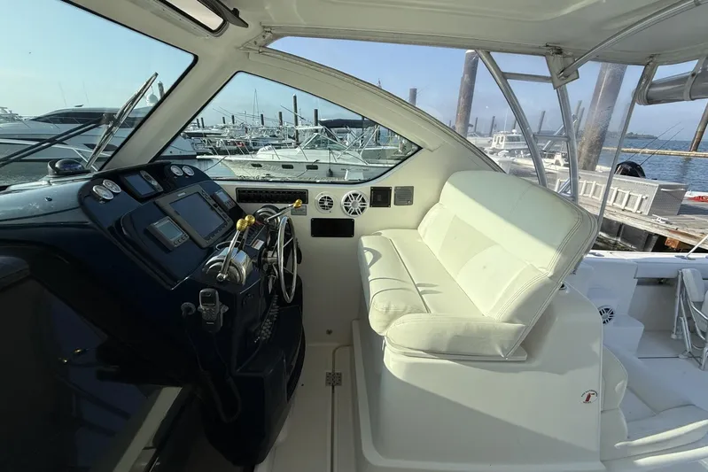  Yacht Photos Pics 2008 Tiara Yachts 3000 Open helm with white seating and marina view.