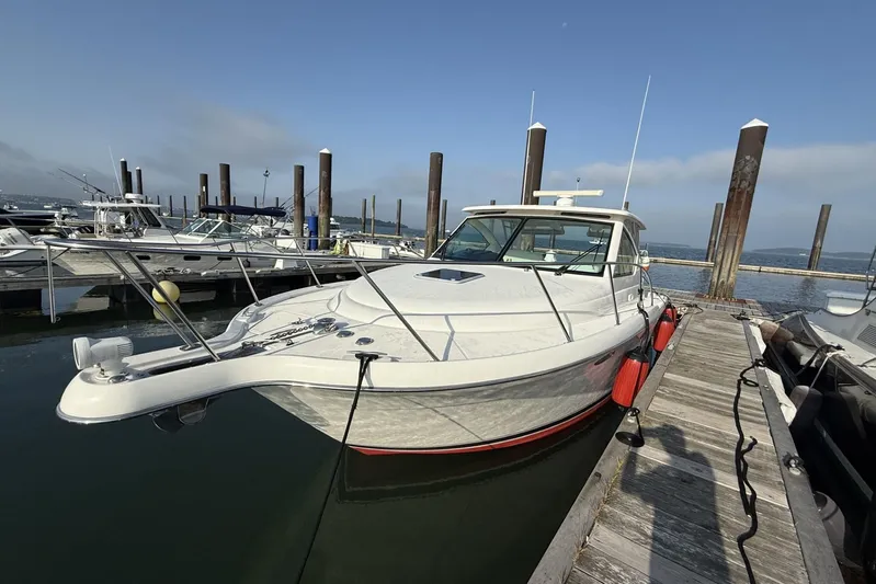  Yacht Photos Pics 2008 Tiara Yachts 3000 Open docked at marina, clear sky, calm water.