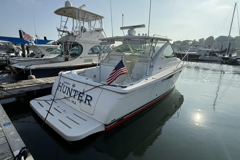  Yacht Photos Pics 2008 Tiara Yachts 3000 Open docked, displaying American flag, sunny marina setting.