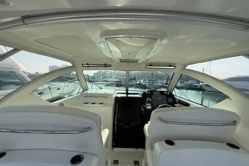  Yacht Photos Pics 2008 Tiara Yachts 3000 Open interior with helm, marina view, and white seating.