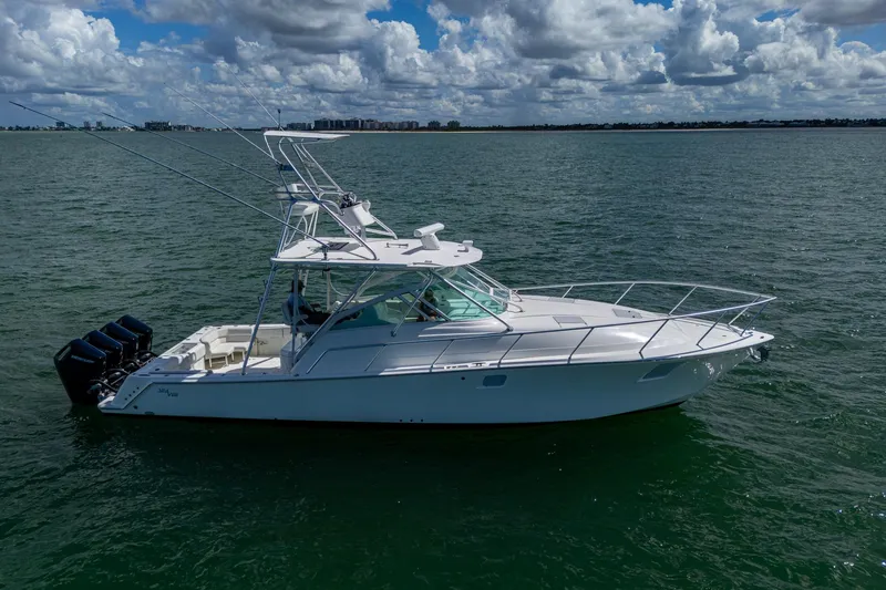Absent Minded Yacht Photos Pics 2014 SeaVee 430 boat on calm water under a partly cloudy sky.