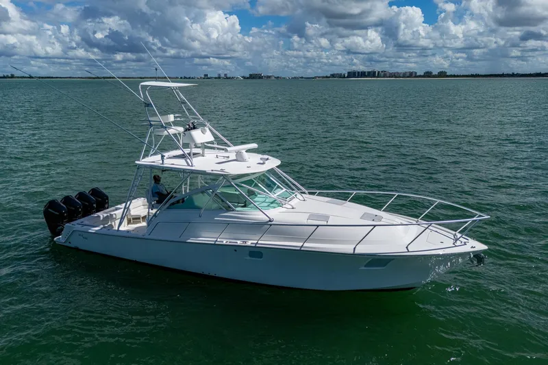 Absent Minded Yacht Photos Pics 2014 SeaVee 430 boat on open water under cloudy sky.