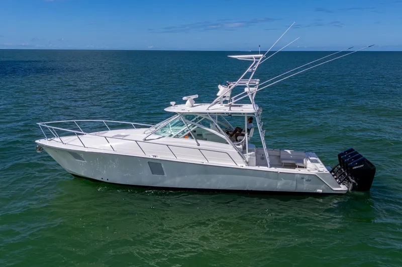 Absent Minded Yacht Photos Pics 2014 SeaVee 430 boat on open water, featuring sleek design and multiple outboard engines.