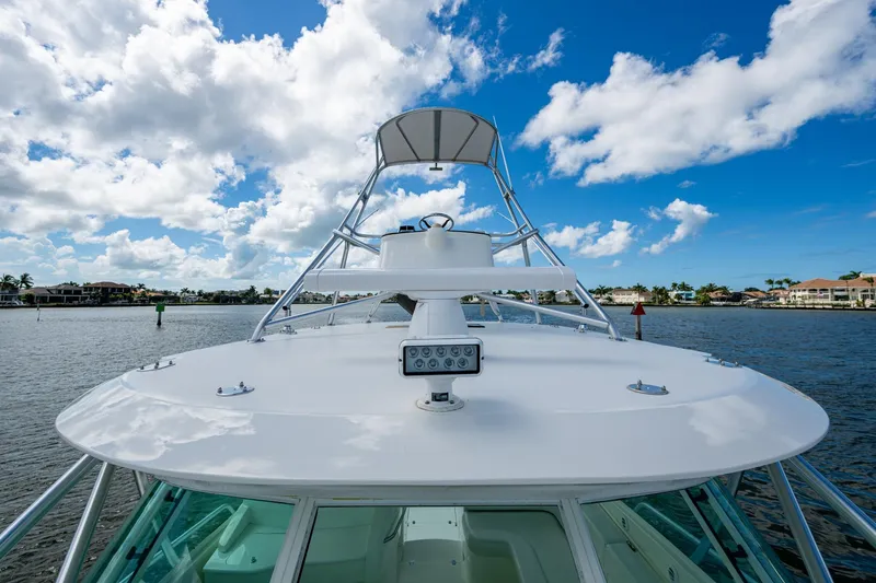 Absent Minded Yacht Photos Pics 2014 SeaVee 430 boat on water under blue sky with clouds.