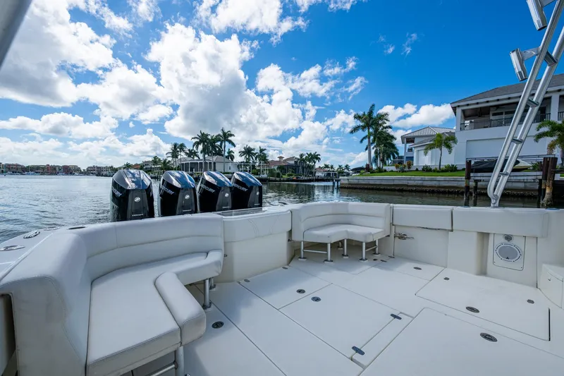 Absent Minded Yacht Photos Pics 2014 SeaVee 430 boat with multiple outboard engines, docked near waterfront homes.