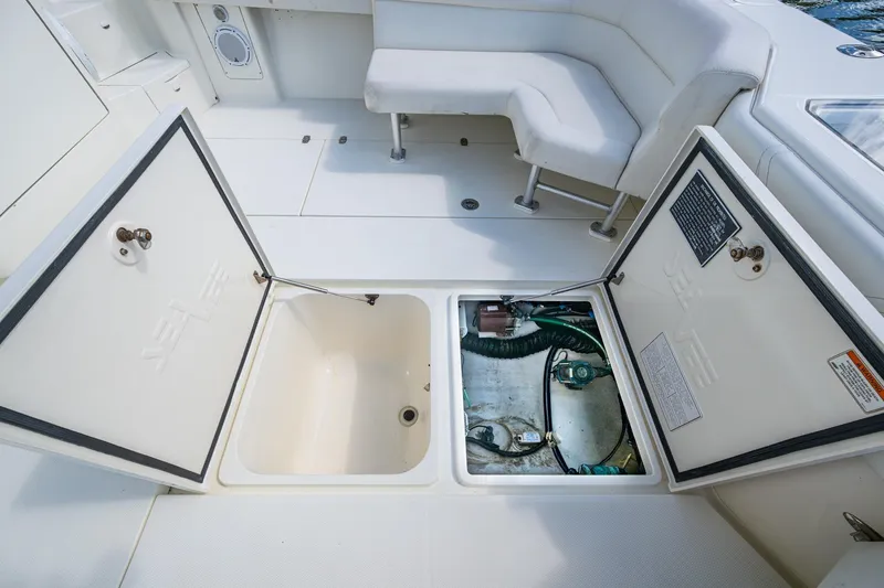 Absent Minded Yacht Photos Pics 2014 SeaVee 430 boat deck with open storage compartments and seating area.
