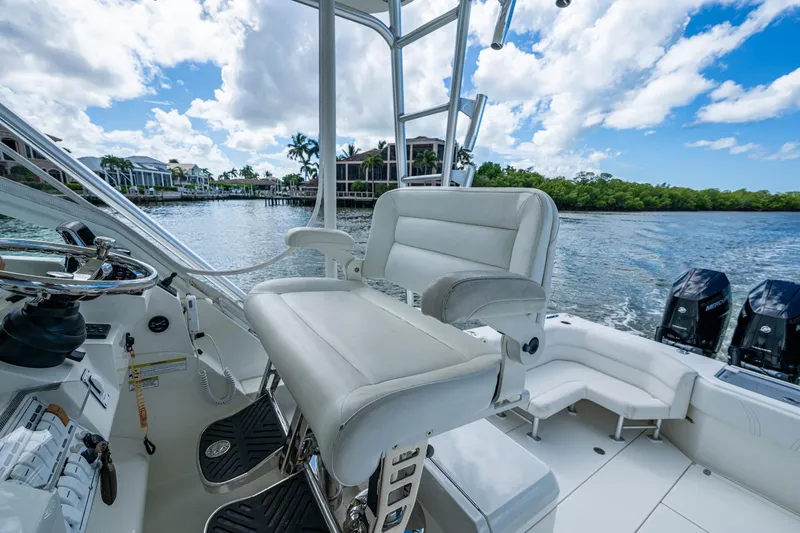 Absent Minded Yacht Photos Pics 2014 SeaVee 430 boat interior with helm seat, steering wheel, and outboard motors.