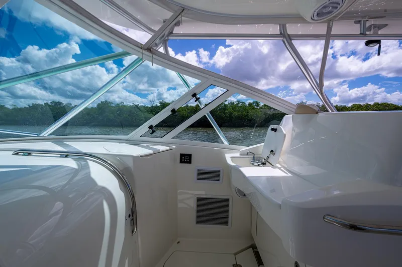 Absent Minded Yacht Photos Pics Interior view of 2014 SeaVee 430 boat with sleek design and scenic water backdrop.