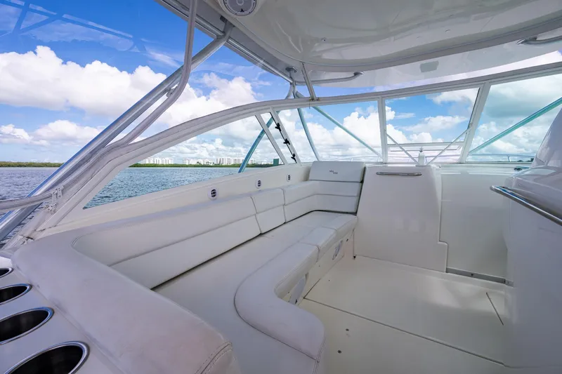 Absent Minded Yacht Photos Pics Luxurious interior of 2014 SeaVee 430 boat with white seating and panoramic windows.