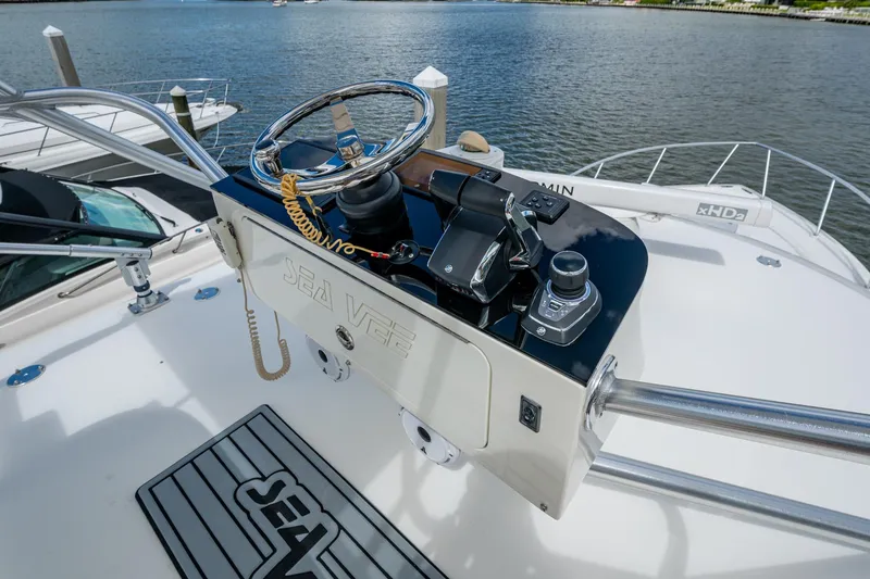 Absent Minded Yacht Photos Pics 2014 SeaVee 430 boat helm with steering wheel and controls, docked by the water.