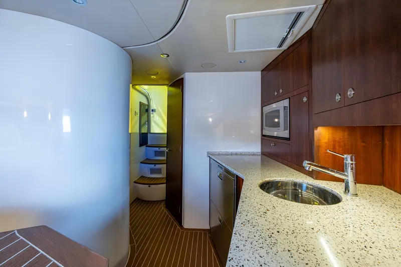 Absent Minded Yacht Photos Pics Luxurious interior of 2014 SeaVee 430 yacht with modern kitchen amenities.