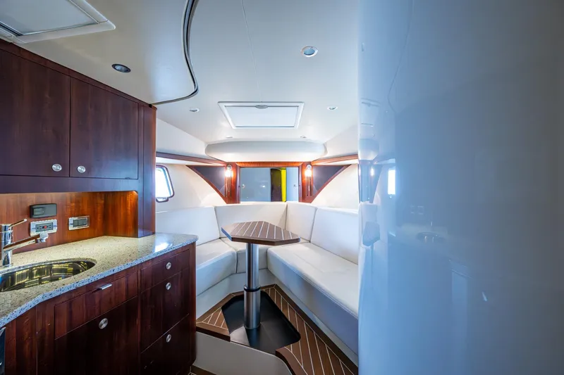 Absent Minded Yacht Photos Pics Luxurious interior of 2014 SeaVee 430 yacht with modern kitchen and seating area.