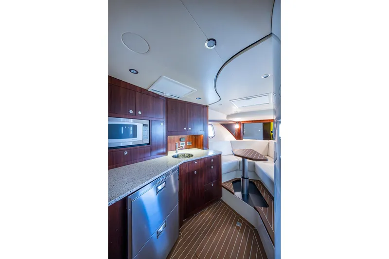 Absent Minded Yacht Photos Pics Luxurious interior of 2014 SeaVee 430 yacht with modern kitchen and seating area.