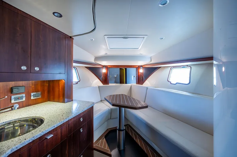 Absent Minded Yacht Photos Pics Luxurious interior of 2014 SeaVee 430 yacht with modern kitchen and seating area.