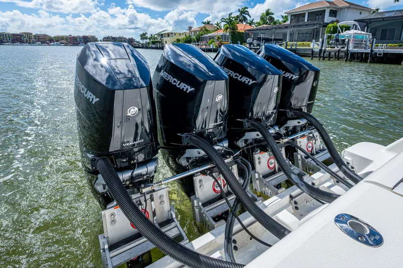 Absent Minded Yacht Photos Pics Four Mercury Verado outboard engines on a 2014 SeaVee 430 boat, docked by waterfront homes.