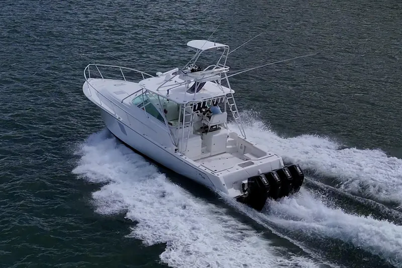 Absent Minded Yacht Photos Pics 2014 SeaVee 430 boat cruising on water with powerful outboard engines.
