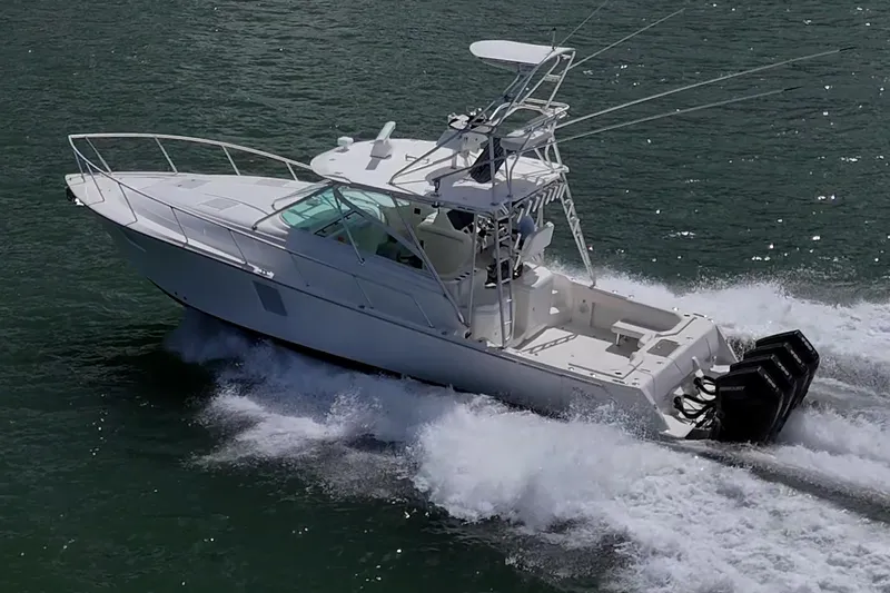Absent Minded Yacht Photos Pics 2014 SeaVee 430 boat cruising on water with powerful outboard engines.