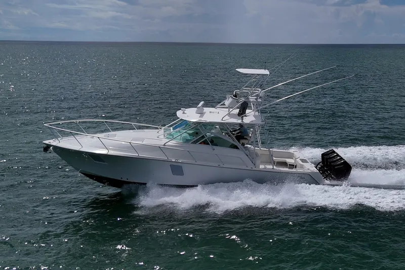 Absent Minded Yacht Photos Pics 2014 SeaVee 430 boat cruising on open water, side view.