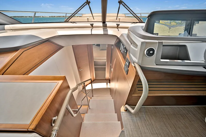Mine Escape Yacht Photos Pics Interior stairs of 2020 Princess F55 Flybridge yacht with wooden finish.