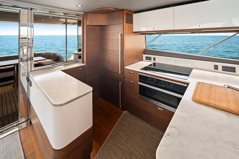 Mine Escape Yacht Photos Pics Modern kitchen interior of 2020 Princess F55 Flybridge yacht with ocean view.