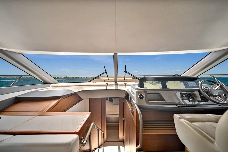 Mine Escape Yacht Photos Pics Interior view of 2020 Princess F55 Flybridge yacht with ocean backdrop.