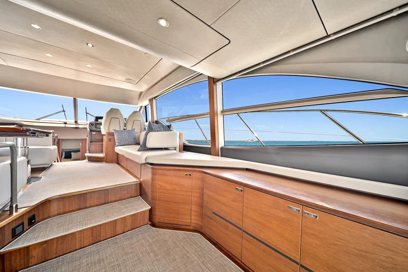 Mine Escape Yacht Photos Pics 2020 Princess F55 Flybridge yacht interior with modern wood cabinetry and panoramic windows.