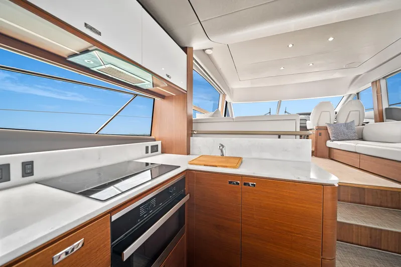 Mine Escape Yacht Photos Pics 2020 Princess F55 Flybridge yacht interior with modern kitchen and seating area.