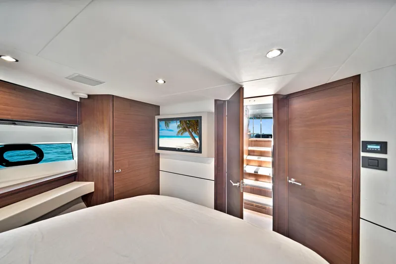 Mine Escape Yacht Photos Pics Luxurious bedroom interior of 2020 Princess F55 Flybridge yacht with modern amenities.