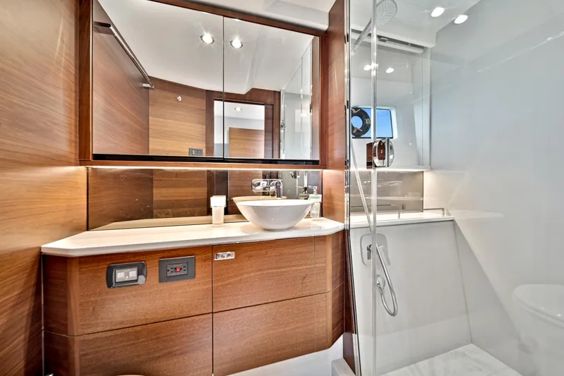 Mine Escape Yacht Photos Pics Modern bathroom on 2020 Princess F55 Flybridge yacht with wood accents and glass shower.