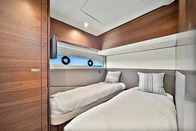 Mine Escape Yacht Photos Pics Twin bedroom on a 2020 Princess F55 Flybridge yacht with modern wood paneling.