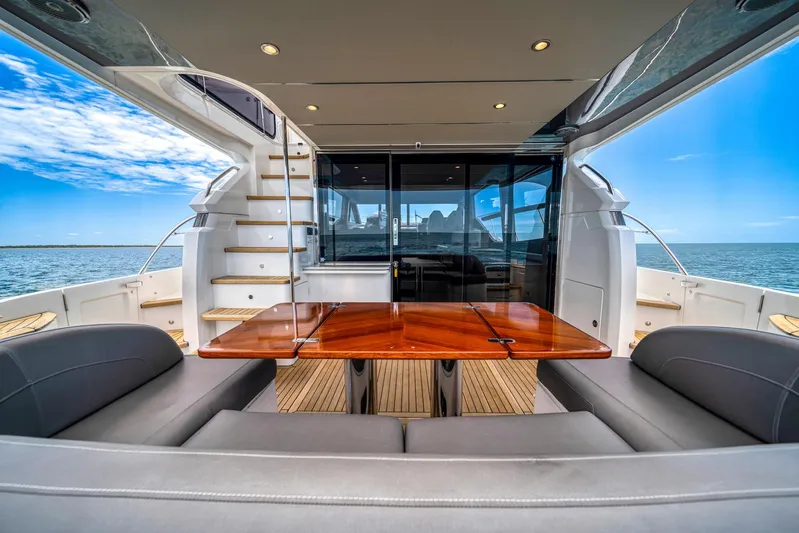 Mine Escape Yacht Photos Pics Luxury 2020 Princess F55 Flybridge yacht interior with ocean view and elegant seating area.