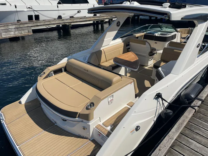  Yacht Photos Pics 2021 Sea Ray SLX 310 boat docked, featuring spacious seating and sleek design.