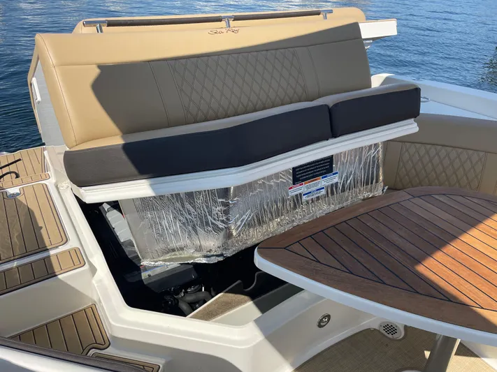  Yacht Photos Pics 2021 Sea Ray SLX 310 boat interior with tan seating and wooden table.