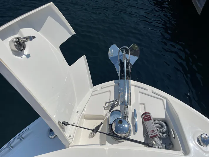  Yacht Photos Pics 2021 Sea Ray SLX 310 boat anchor system on deck, open hatch, calm water background.