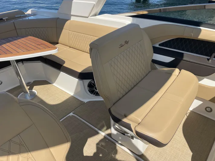  Yacht Photos Pics Luxurious seating on 2021 Sea Ray SLX 310 boat with tan upholstery and wooden table.