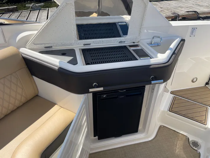  Yacht Photos Pics 2021 Sea Ray SLX 310 boat interior with kitchenette and seating area.