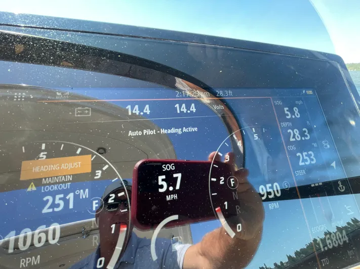  Yacht Photos Pics Dashboard of a 2021 Sea Ray SLX 310 boat showing autopilot and speed at 5.7 MPH.